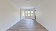 Located at 160 Simsbury Rd in West Hartford, CT, this well-appointed 2-bedroom, 1-bathroom unit offers a thoughtfully designed single-floor layout with clean, modern finishes throughout. Light wood-tone luxury vinyl plank flooring flows consistently across every room, complementing the crisp white walls and bright, airy atmosphere.

The living room is a standout feature, boasting an elegant bay window arrangement that floods the space with natural light and offers pleasant views of surrounding greenery. Crown molding adds a refined architectural touch to this welcoming gathering area.

The kitchen is outfitted with white shaker-style cabinetry accented by gold hardware, a white subway tile backsplash, quartz countertops, and stainless steel appliances including a range and over-the-range microwave. A window above the counter brings in additional natural light.

Both bedrooms are comfortably sized, featuring large windows with tree-lined views, ample closet space with bi-fold doors, and a serene, neutral palette. The primary bedroom offers a notably generous footprint.

The bathroom is stylishly appointed with a white vanity, black hardware accents, and a walk-in shower clad in classic white subway tile with a sleek frameless sliding glass door. The overall design is cohesive, modern, and move-in ready.