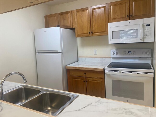 Galley kitchen with new dishwasher in countertops - 3804 59th Ave W