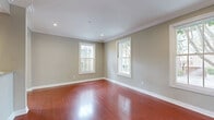 Located at 1236 N Flores St in the heart of West Hollywood, this well-appointed 1-bedroom, 1-bathroom residence blends classic architectural details with modern updates. Rich, warm-toned hardwood floors run throughout the entire unit, complemented by crisp crown molding and recessed lighting that lend a polished, cohesive feel. The combined dining and living area is bright and inviting, with multiple double-hung windows framing views of the surrounding neighborhood and allowing generous natural light to fill the space. A striking exposed brick accent wall adds character and texture to the living area. The kitchen is thoughtfully designed with deep-toned cabinetry, granite countertops, a tile backsplash, a gas range with a custom hood, and stainless steel appliances, including a full-sized refrigerator. The spacious bedroom features large windows with outdoor views, crown molding, and a double sliding-door closet providing ample storage. The bathroom offers classic black-and-white mosaic tile flooring, a full tub and shower, a pedestal sink, and a granite-topped vanity. Two closets and a hallway complete the functional layout, making efficient use of the well-proportioned floor plan throughout.