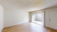 Located at 1213 Norwegian Ave in Modesto, CA, this single-floor, 2-bedroom, 1-bathroom unit offers a practical and comfortable layout. Throughout the main living areas, light wood-style flooring lends a clean, bright aesthetic, complemented by white walls and textured ceilings. The living room is a well-proportioned space featuring a sliding glass door that opens directly onto a private patio, filling the room with natural light and providing easy outdoor access. Adjacent to the living room, the combined dining and kitchen area is efficiently designed with white cabinetry, granite-look countertops, a ceiling fan, and white appliances including a refrigerator and range. The primary bedroom is generously sized with carpeted flooring, multiple closets for ample storage, and direct hallway access. The second bedroom also features carpet, a ceiling fan, and a window with natural light. A hallway connects the rooms and leads to the full bathroom, which includes a tub/shower combo with clean white tile surround. With three closets distributed throughout the unit and a private patio, the space offers practical storage and outdoor living options in a straightforward, well-maintained floor plan.