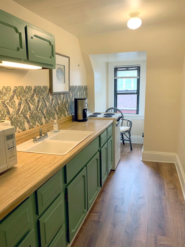 cozy kitchenette with gas stove, wood countertops, pantry, refrigerator, microwave and coffee maker - 2915 Ludlow Rd