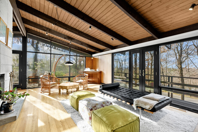 Living room on the second floor with access to the balcony facing the front yard and the deck. - 19 Cottontail Ln