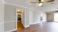 Located on West End Avenue in Nashville, TN, this well-appointed 3-bedroom, 3-bathroom residence offers a thoughtfully designed single-floor layout. Warm hardwood-style flooring flows throughout, complemented by crisp crown molding and ceiling fans in every room, creating a cohesive and polished aesthetic.

The spacious living room is filled with natural light from large sliding glass doors that open to a private balcony, offering an inviting indoor-outdoor connection. The kitchen is well-equipped with white cabinetry, clean white countertops, stainless steel appliances including a range, microwave, and dishwasher, and ample storage throughout.

The generously sized primary bedroom provides a comfortable retreat, while the two additional bedrooms each feature ceiling fans, crown molding, and natural light from well-placed windows. Two closets offer practical storage solutions throughout the home.

Each of the three bathrooms is finished with white cabinetry, dark granite-style countertops, framed mirrors, and a clean, classic tile surround in the tub-shower combinations. Neutral wall tones carry throughout the home, lending a calm and versatile backdrop. The overall ambiance is clean, functional, and move-in ready.