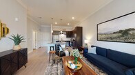 Located in Nashville, TN (37076), this 1-bedroom unit offers a thoughtfully designed single-floor layout that balances modern finishes with everyday functionality. The open-concept living and kitchen area serves as the heart of the home, where light hardwood-style flooring flows seamlessly throughout. The living room features neutral gray walls, crown molding, and large windows with a glass-panel entry door that invite natural light and outdoor views. The kitchen is a standout feature, showcasing dark espresso cabinetry, granite countertops, a subway tile backsplash, stainless steel appliances — including a refrigerator, range, microwave, and dishwasher — and a peninsula island with bar seating, ideal for casual dining or meal prep. The bedroom is a serene retreat with plush carpeting, generous wall space, and a large window that frames greenery outside. The bathroom continues the home's cohesive aesthetic with dark cabinetry, granite countertops, wood-look flooring, and a tub-shower combo. Throughout the unit, a consistent palette of cool grays, warm wood tones, and modern fixtures creates a clean, contemporary ambiance suited for comfortable Nashville living.