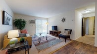 Located at 2302 High Ridge Trail in Fitchburg, Wisconsin, this single-floor residence offers a well-organized layout that balances comfort and functionality across its key living spaces.

The living room serves as the central gathering area, featuring a mix of carpeted and hardwood-style flooring. Large sliding glass doors fitted with vertical blinds allow generous natural light to fill the room and provide direct access to an outdoor patio. A wall-mounted air conditioning unit ensures year-round comfort, and baseboard heating is present throughout the home.

The kitchen is equipped with dark wood cabinetry, white laminate countertops, and a coil-burner electric range with an overhead exhaust hood, providing practical cooking facilities.

Adjacent to the kitchen, the dining area features warm wood-look flooring, a ceiling fan with integrated lighting, and louvered closet doors that offer additional storage options — creating a clean, functional space for everyday meals.

The bedroom is a quietly comfortable room with plush carpet, a natural window that brings in soft light, baseboard heating, and a louvered closet. The bathroom includes a wood-toned vanity with a marble-patterned countertop, a medicine cabinet with shelving, and a shower-tub combination, offering all essential amenities in a compact, efficient layout.