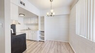 Located at 1130 E Orange St in Tempe, Arizona, this single-story 2-bedroom, 2-bathroom home offers a well-organized layout with light wood-style flooring throughout. The combined living and dining area is bright and open, featuring a decorative chandelier, a shiplap-accented accent wall, and built-in shelving that adds functional character. The galley-style kitchen is efficiently designed with white upper and lower cabinetry, a stainless sink with light countertops, and black appliances including a range and refrigerator. Both bedrooms are comfortably sized, with the primary bedroom offering generous square footage. Each bedroom features painted cinder block accent walls, ceiling fans with lighting, vertical blinds allowing natural light, and light wood-style flooring. The two bathrooms are finished in a clean, neutral palette — one includes a walk-in shower with sliding glass doors, while the other features a full tub and shower combo with white surrounds and a white vanity with cabinet storage. Four closets throughout the home provide ample storage. A hallway connects the main living spaces to the bedrooms and bathrooms, contributing to a functional and straightforward floor plan suited for everyday living.