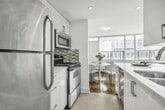 This 820 square foot apartment in Toronto offers a thoughtful layout with two bedrooms and one bathroom. The space is characterized by its bright, open-concept design, featuring a spacious living area that seamlessly connects to a modern kitchen. Light wood flooring throughout enhances the airy feel, complemented by crisp white walls.

The kitchen, partially visible through an archway, boasts stainless steel appliances and ample cabinet space. A small peninsula extends from the kitchen, providing a casual dining spot or extra counter space. Overhead, a contemporary light fixture adds a touch of style to the living area.

Natural light floods the space through large windows, creating a welcoming atmosphere. The primary bedroom, measuring 150 square feet, offers ample space for a comfortable retreat. A hallway leads to the second bedroom and bathroom, ensuring privacy.

Located at 225 Davisville Ave in Toronto, this apartment combines functionality with modern aesthetics, making efficient use of its 820 square feet to create a comfortable living environment.