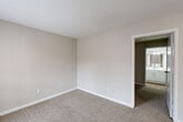 This 450 square foot apartment in Houston, TX offers a thoughtful layout within its compact footprint. The single-floor unit comprises one bedroom, two bathrooms, a living room, kitchen, and closet space. The primary bedroom measures 100 square feet, providing a cozy retreat.

The living area showcases a blend of flooring materials, with hardwood in the entry and carpeting in the main space. Large windows allow natural light to flood the room, while a two-tone wall paint scheme adds visual interest. The kitchen, though compact, features modern stainless steel appliances and wood-look flooring.

Both bathrooms are efficiently designed, with one featuring a shower/tub combo and a patterned shower curtain. The other bathroom boasts a sleek vanity with ample storage and a large mirror. Throughout the apartment, neutral color schemes dominate, creating a bright and airy atmosphere.

Despite its small size, the apartment maximizes space with smart storage solutions and an open-concept design. The overall ambiance is modern and fresh, ideal for urban dwellers seeking a low-maintenance living space in the heart of Houston.