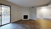 Located at 2864 Dublin Blvd in Colorado Springs, CO, this well-appointed 2-bedroom, 3-bathroom residence offers a thoughtfully designed single-floor layout. The open-concept living, dining, and kitchen area serves as the heart of the home, featuring rich wood-look flooring throughout. A standout white-mantled fireplace anchors the living room, adding warmth and character, while sliding glass doors lead to a private balcony that brings in natural light and outdoor views. The kitchen is outfitted with stainless steel appliances — including a refrigerator, gas range, and built-in microwave — complemented by white cabinetry, grey stone countertops, and a breakfast bar that connects seamlessly to the dining area. Both bedrooms are carpeted for comfort, with the primary bedroom offering a generous footprint, a dedicated closet, and easy access to one of the three bathrooms. The bathrooms feature wood-look flooring, white vanities with grey countertops, and a tub/shower combination. Additional conveniences include a dedicated laundry area and a utility room. The neutral color palette and clean finishes throughout create a bright, move-in ready atmosphere.