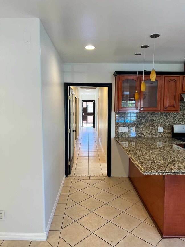 Pasillo con puerta principal que da acceso a la sala de estar con 4 dormitorios. - 2330 S Mansfield Ave
