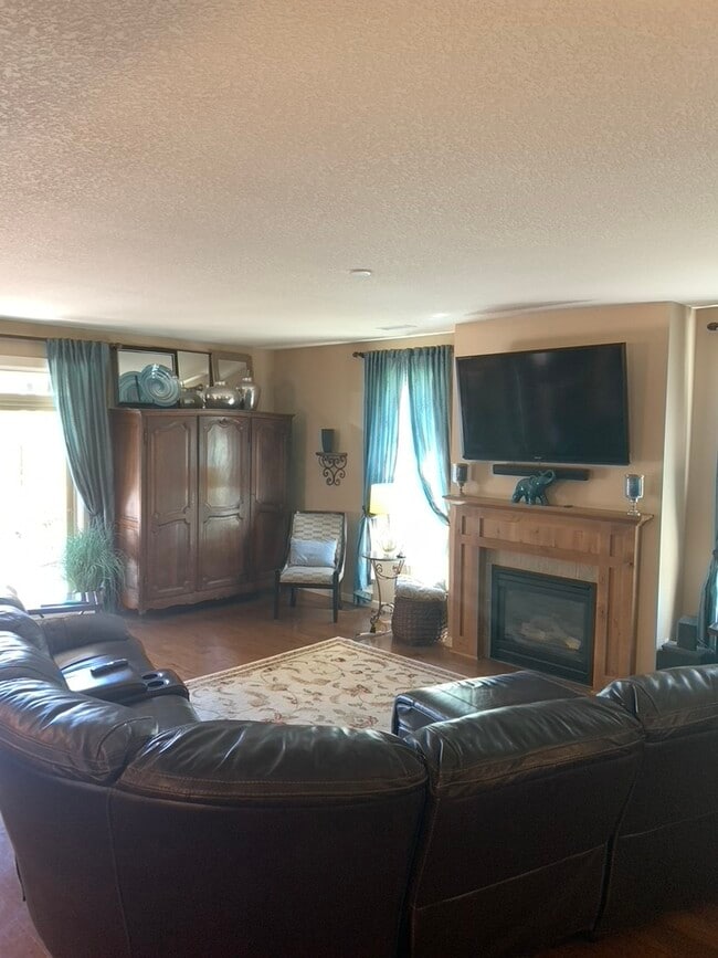 Living Room with sectional w/ recliners. - 5401 NE 66th Dr