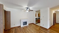 This 860 square foot apartment in Madison, Wisconsin offers a well-designed living space with two bedrooms and one bathroom. The interior is characterized by its warm hardwood flooring throughout, creating a cohesive and inviting atmosphere. The living room is spacious and bright, featuring sliding glass doors that provide ample natural light and a view of the outdoors. A notable feature is the white marble fireplace, adding a touch of elegance to the main living area.

The kitchen is modern and functional, equipped with wooden cabinets, granite countertops, and stainless steel appliances. It includes a refrigerator, stove, and microwave, making it ready for immediate use. The galley-style layout maximizes efficiency in a compact space.

The bedrooms are well-proportioned, with the primary bedroom measuring 150 square feet. Each room has a window, allowing for natural light and ventilation. The bathroom is clean and practical, featuring a shower-tub combination, a single vanity, and neutral tiling.

Additional amenities include baseboard heating, ceiling fans, and closet space in the bedrooms. The apartment's single-floor layout enhances accessibility and ease of movement throughout the space. Located at 7742 Radcliffe Drive, Apt B, this apartment offers a comfortable and practical living solution in a residential area of Madison.