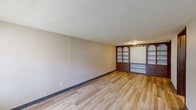Located at 403 Rockdale Ave in Boardman, Ohio, this one-bedroom, one-bathroom unit offers a practical and well-organized single-floor layout. Light wood-look flooring runs consistently throughout the space, providing a clean and cohesive look complemented by neutral-toned walls and textured ceilings.

The living room is a standout area, featuring a distinctive built-in wall unit with arched shelving, display niches, and lower cabinet storage — a classic architectural detail that adds character and functional storage. Natural light enters through a large window, and a wall-mounted HVAC unit ensures year-round comfort.

The kitchen is equipped with warm wood cabinetry, a light countertop with a stainless steel sink, and a tile backsplash. A built-in open shelving unit adjacent to the kitchen provides additional storage or pantry space.

The bedroom offers a comfortable footprint with a generous closet featuring bifold wood-panel doors, interior shelving, and hanging rods — providing ample organization options. The textured ceiling and consistent flooring carry through this room as well.

The bathroom is straightforward and functional, featuring a single-sink vanity with wood cabinetry, a full tub-shower combo, and wood-look flooring that ties seamlessly into the rest of the unit.