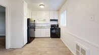 Located at 4015 Covington Hwy in Decatur, GA, this single-floor, three-bedroom unit offers a practical and well-organized layout. The living areas feature durable hardwood-style flooring in neutral tones, complemented by warm beige walls and white trim throughout, creating a clean and cohesive aesthetic. Natural light filters in through multiple windows fitted with blinds, brightening the main living spaces. The entry area opens into a light-filled room with a front door and side window, providing a welcoming introduction to the home. The kitchen is equipped with ample white cabinetry, a stainless steel sink, laminate countertops, a black electric range, and a stainless steel refrigerator, with light flooring and a window that adds natural brightness. All three bedrooms are carpeted for comfort and each includes a ceiling fan with light fixture. The generously sized primary bedroom offers its own closet, while the additional bedrooms also feature closet access and windows. A hallway connects the rooms efficiently, and three total closets provide solid storage throughout. The overall layout is functional and well-suited for everyday living, with consistent finishes that give the space a tidy, move-in-ready appearance.