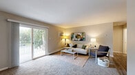 Located at 200 W 75th Pl in Merrillville, Indiana, this single-floor residence offers a thoughtfully designed layout encompassing generous living space across a well-organized floor plan. The unit includes two distinct living areas, providing flexible options for lounging and entertaining. The primary living room features plush carpeting, warm neutral tones, and a sliding glass door that opens to a private balcony overlooking a tree-lined exterior — an inviting spot for outdoor relaxation. The dining room is a defined, intimate space finished with wood-look flooring, a ceiling fan, and a decorative round mirror that adds depth to the room. The galley-style kitchen is well-appointed with gray shaker cabinetry, granite-look countertops, stainless steel appliances including a refrigerator, electric range, and dishwasher, and durable hardwood-style flooring throughout. The bedroom offers comfortable carpeting, a natural window with greenery views, a built-in closet, and baseboard heating. The full bathroom includes a tub/shower combination with updated brushed nickel fixtures and wood-look tile flooring. A dedicated closet provides additional storage, completing this functional and comfortable Merrillville residence.