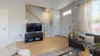 Located at 175 Oakland Rd in South Windsor, Connecticut, this two-story home offers a thoughtfully designed layout with modern finishes throughout. The main level welcomes you with a bright entryway featuring a transom-lit front door and light hardwood flooring that flows into the living and kitchen areas. The living room is generously sized with multiple windows that flood the space with natural light. The kitchen is a standout, showcasing rich dark espresso cabinetry, granite countertops, a classic subway tile backsplash, stainless steel appliances, and a peninsula with bar seating — ideal for casual dining or entertaining. A convenient half bath completes the main floor. Upstairs, the primary bedroom is a serene retreat with vaulted ceilings, patterned drapery, and access to a spacious walk-in closet outfitted with wire shelving and ample hanging space. Additional bedrooms are well-proportioned with plush carpeting, natural light, and closet access. The full bathroom on this level features large-format tile flooring, a soaking tub with shower, a dark-toned vanity with a white countertop, and a window providing natural ventilation. The home's neutral color palette and consistent design language create a cohesive and welcoming ambiance throughout.