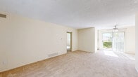 Located at 4515 3rd Street in La Mesa, California, this single-floor, 2-bedroom, 2-bathroom home offers a functional and comfortable layout. The interior is finished with warm neutral tones and a combination of carpet and hardwood-style flooring throughout.

The galley-style kitchen is efficiently designed with white cabinetry, ample counter space, a double sink, and white appliances including a range and refrigerator. A window provides natural light, making the space bright and practical. Adjacent to the kitchen is a dedicated dining area that flows into the living room, which features plush carpet, a textured ceiling, and a sliding glass door that invites in natural light and outdoor views.

Both bedrooms are carpeted and generously proportioned, each featuring built-in closet systems with shelving and hanging rods. Large windows with vertical blinds allow natural light to fill the rooms while offering greenery views. The primary bedroom is notably spacious and well-lit.

The two bathrooms are clean and functional. One features a tiled tub-shower combo with chrome fixtures, while the other includes a walk-in tiled shower and a wide vanity with a light stone countertop and large mirror. Hardwood-style flooring completes each bathroom. A hallway connects all rooms, offering a smooth and logical flow throughout the home.