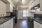 Located at 3896 Chippewa Road in Memphis, TN, this single-story unit offers a well-planned layout with one bedroom, two bathrooms, a living room, kitchen, and hallway. Wood-look flooring runs throughout, providing a cohesive and easy-to-maintain finish, while textured ceilings add a classic touch to each room.

The galley-style kitchen is efficiently designed with white shaker cabinetry lining both sides, dark granite-style countertops, a mosaic tile backsplash, and black appliances including an electric range, dishwasher, and refrigerator. A window at the end of the kitchen allows natural light to filter in, and the layout opens toward the main living areas via a connecting hallway.

The living room is a comfortable, open space highlighted by a large window fitted with vertical blinds that bring in natural light and offer outdoor views. A front entry door provides direct access to the exterior from this area.

The bedroom is a well-proportioned private retreat with its own window and wood-look flooring, offering a calm and quiet atmosphere. The two bathrooms include a vanity with white cabinetry and a framed mirror, as well as a full tub-shower combination with floor-to-ceiling tile surround in a neutral stone-look finish. The overall design is clean, functional, and move-in ready.
