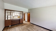 Located at 600 Weakley Ln in Smyrna, Tennessee, this one-bedroom, one-bathroom unit offers a practical and efficient single-floor layout. The living and kitchen areas feature light wood-style vinyl flooring, lending a clean and consistent look throughout the main space. The kitchen is well-equipped with ample white cabinetry trimmed in warm wood tones, a light butcher-block-style countertop, a double-basin stainless steel sink, and white appliances including a coil-top electric range and a full-size refrigerator. A dedicated utility room off the kitchen houses the water heater, providing convenient in-unit access. The bedroom is carpeted in a neutral tone, offering a comfortable retreat, and is illuminated by a ceiling light fixture and a window with outdoor views. A hallway connects the main living areas to the bathroom, which features a marble-patterned vanity countertop with an integrated sink, a large mirror, and overhead lighting. Textured ceilings are consistent throughout the unit, and wood-trimmed interior doors add a warm, classic touch. This unit provides a straightforward, functional living experience in a convenient Smyrna location.