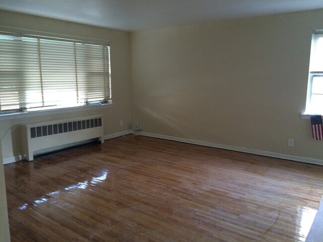 1st floor living room featuring hardwood floors - 210 East 238th Street