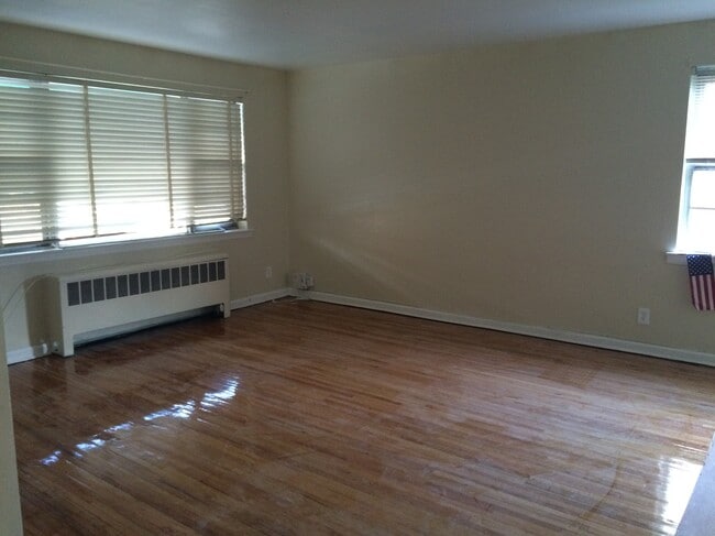1st floor living room featuring hardwood floors - 210 East 238th Street