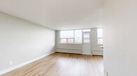 Located at 345 Merton Street in Toronto's Davisville Village neighbourhood, this well-appointed one-bedroom, one-bathroom unit offers a thoughtfully designed layout across a single floor. The open living area is bright and airy, featuring light hardwood-style flooring throughout and large floor-to-ceiling windows that flood the space with natural light and frame sweeping views of the Toronto skyline. Baseboard heating runs along the window walls, complementing the clean, modern aesthetic.

The kitchen is a standout feature, finished with crisp white cabinetry accented by matte black hardware, a striking marble-look tile backsplash, and matching marble-look floor tiles. Stainless steel appliances, including a full-sized refrigerator and dishwasher, complete the functional and stylish space, which connects seamlessly to the living area via an open pass-through.

The bedroom is a comfortable and well-proportioned retreat, featuring the same warm hardwood-style flooring, soft neutral walls, and a built-in sliding-door closet for ample storage. A secondary window provides additional natural light and city views.

The bathroom is finished to a high standard, with full marble-look tile surround in the tub/shower combination, chrome fixtures, and a granite-topped vanity, creating a clean and refined atmosphere throughout.