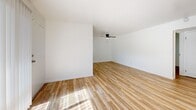 Located at 1715 Central Ave in Alameda, CA, this well-appointed one-bedroom, one-bathroom unit offers a clean, modern aesthetic throughout. Light wood flooring flows seamlessly across all rooms, complementing the crisp white walls and creating a bright, cohesive feel.

The open-concept living and dining area is spacious and airy, bathed in natural light from large sliding glass doors that lead to the outside. A ceiling fan adds practical comfort to the living space. The kitchen is efficiently designed with white cabinetry, white countertops, stainless steel appliances including a refrigerator, electric range, and microwave, plus a window above the sink that brings in additional natural light.

The bedroom is a comfortable, well-lit retreat featuring a ceiling fan, a window with blinds, and a mirrored sliding-door closet that enhances the sense of space. Additional closet storage is available elsewhere in the unit.

The bathroom maintains the clean, modern palette with a white vanity, matte black fixtures, a combined tub and shower with glass sliding doors, and a window that allows for natural ventilation and light. A hallway connects the various rooms, contributing to a logical and functional layout throughout this tidy Alameda residence.