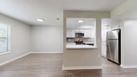 Located at 2691 Cypress Bend Dr in Clearwater, Florida, this single-floor residence offers a well-designed layout with contemporary finishes throughout. Wood-look luxury vinyl plank flooring flows seamlessly across all main living areas, complemented by neutral wall tones and textured ceilings that create a clean, cohesive aesthetic.

A welcoming entryway hallway leads into the open living and dining area, where large windows with horizontal blinds allow abundant natural light to fill the space. A black-accented corner fireplace serves as a striking focal point in the living room, adding warmth and character. A glass door provides direct access to the exterior.

The kitchen is equipped with white shaker-style cabinetry, light quartz countertops, a classic subway tile backsplash, and a full suite of stainless steel appliances including a range, over-the-range microwave, dishwasher, and refrigerator. A pass-through window with a breakfast bar connects the kitchen to the main living area, enhancing the open feel.

The bedroom features a ceiling fan, dual windows for natural light, and ample floor space. The bathroom includes a full tub-shower combination with clean white surroundings. A dedicated in-unit laundry closet houses a full-size washer and dryer. This thoughtfully appointed residence offers practical comfort in a desirable Clearwater location.