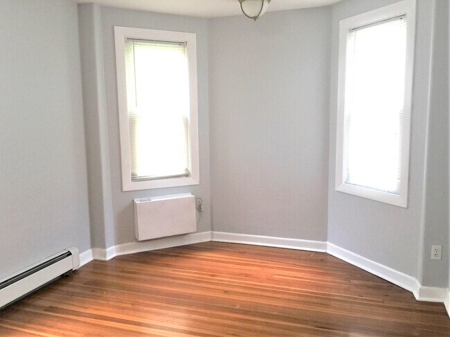 Bedroom with hardwood floors and A/C - 142 Humboldt Ave