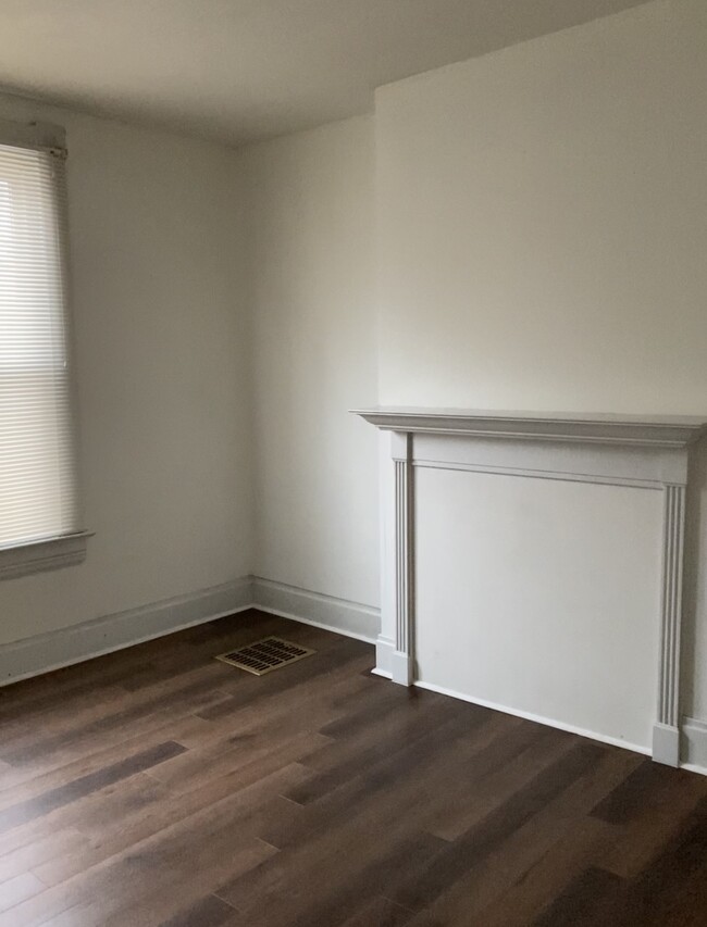 Living room with decorative fireplace, new flooring - 1161 Blackberry Aly