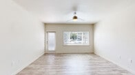 Located at 4142 Morada Ln in Stockton, CA, this single-floor, 3-bedroom, 2-bathroom home offers a clean, modern aesthetic throughout. Light wood-style flooring flows consistently across the living spaces, complementing the neutral, warm-white walls that create a bright and welcoming atmosphere.

The combined kitchen and living room area forms the heart of the home. The living room features a ceiling fan with light fixture, a large picture window with horizontal blinds, and a private exterior door that lets in abundant natural light. The kitchen is outfitted with rich dark-wood cabinetry, white countertops, and stainless steel appliances including a gas range, over-the-range microwave, and dishwasher.

The three bedrooms are well-proportioned, with the primary bedroom offering vaulted ceilings, a ceiling fan, and generous window coverage that fills the room with natural light. Additional bedrooms are bright and functional. The home includes two closets for organized storage.

Both bathrooms are finished with clean white tile surrounds and soaking tub/shower combinations with brushed nickel fixtures. Outside, the property features covered carport parking, professionally landscaped common areas with cypress trees and decorative gravel, and a well-maintained community setting.