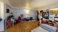Located at 809 S Henderson St in Bloomington, Indiana, this one-bedroom, one-bathroom unit is thoughtfully laid out across a single floor. The living room is the heart of the home, featuring warm hardwood flooring that extends throughout much of the unit. The space is generously sized for its footprint, offering room for both a seating area and a workspace. Multiple windows along the front wall allow natural light to flow in, creating a bright and welcoming atmosphere. The kitchen is efficiently designed with warm wood cabinetry extending to the upper walls, light countertops, and tile flooring. It includes a full range and ample storage, making it practical for everyday cooking. A hallway connects the main living areas to the private bedroom and bathroom. The bedroom is a comfortable, well-proportioned room featuring two windows that bring in natural light from multiple angles, hardwood flooring, and a classic wood door. The bathroom is cleanly appointed with tile flooring and connects conveniently to the hallway. Overall, the unit offers a functional and cozy layout well-suited for single occupancy, with consistent finishes and a warm, lived-in character throughout.