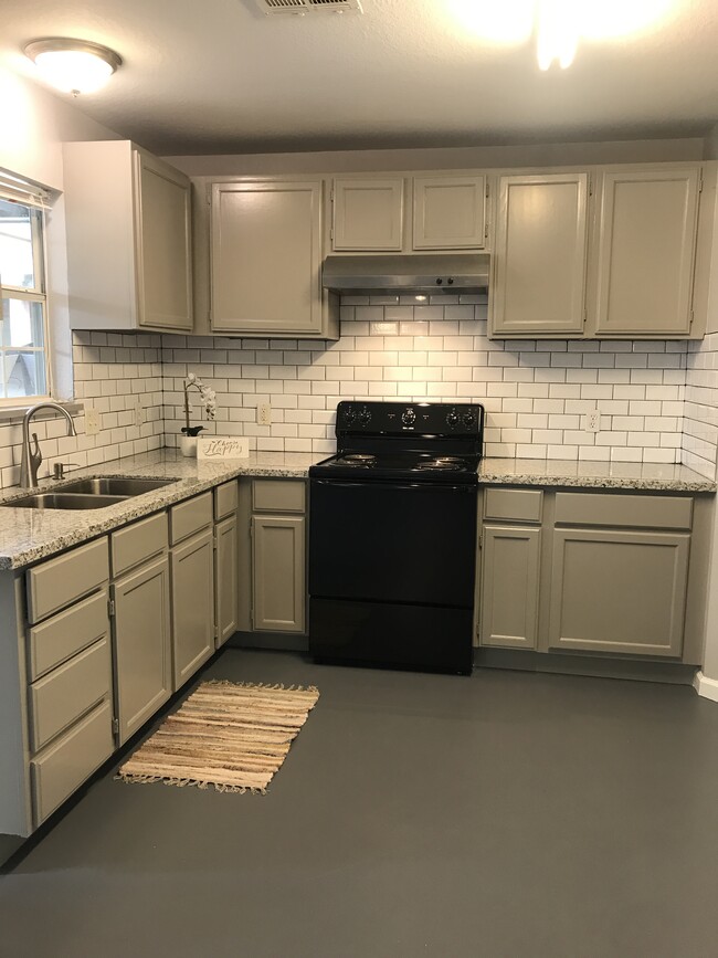 Upgraded kitchen with new counters and stylish new backsplash. - 222 S Kansas Ave