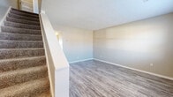Located at 2398 Sterlington Rd in Lexington, Kentucky, this two-story home offers 3 bedrooms and 2 bathrooms across two well-proportioned floors. The main floor features a kitchen equipped with white shaker-style cabinetry, granite-look countertops, a white subway tile backsplash, and black appliances including a range, refrigerator, and dishwasher, complemented by a stainless steel microwave. Wood-look vinyl plank flooring runs throughout the main level, lending a clean and cohesive aesthetic. A hallway and utility room round out the ground floor layout. Upstairs, the three bedrooms are carpeted and each fitted with a ceiling fan, providing comfort and airflow. The spacious primary bedroom includes a double-door closet and direct access to an adjoining bathroom. The additional bedrooms feature natural light from windows with blinds and individual closets. The two bathrooms are finished with wood-look tile flooring and neutral-toned walls; one includes a full bathtub and shower combination, while the other features a vanity with white cabinetry and brushed nickel hardware. Two hallways connect the spaces across both floors, ensuring a functional and easy-to-navigate layout throughout this well-maintained Lexington home.