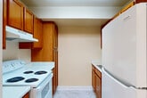 Located at 3601 Gallatin St in Hyattsville, MD, this residence offers three bedrooms, one bathroom, and a well-organized single-floor layout. The living room is generously sized, featuring soft carpeting and a large sliding glass door that fills the space with natural light and opens to a lush green outdoor view. A dedicated hallway connects the main living areas to the private quarters, aided by a closet for additional storage.

The kitchen is designed in a galley style, featuring warm wood cabinetry, light marble-patterned flooring, and white appliances including a range and full-size refrigerator, providing a functional and efficient cooking space.

Each of the three bedrooms is carpeted and equipped with a ceiling fan with integrated lighting. The expansive primary bedroom includes a window overlooking greenery, offering a bright and comfortable retreat. The additional bedrooms also feature windows for natural light, and at least one includes a built-in closet with shelving. One bedroom features a distinctive accent wall, adding a touch of character.

The bathroom is clean and straightforward, with white subway tile surrounding a full tub-shower combination and chrome fixtures. Throughout the residence, neutral tones and consistent finishes create a cohesive, calm atmosphere well-suited for comfortable living.