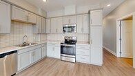 Located at 525 Clancy Ave NE in Grand Rapids, Michigan, this thoughtfully designed 2-bedroom, 2-bathroom residence offers a comfortable and modern living experience across a single floor. The open-concept living, dining, and kitchen area is anchored by light-toned luxury vinyl plank flooring that reflects natural light streaming in through large windows fitted with white blinds. Recessed lighting throughout enhances the clean, airy ambiance.

The kitchen is well-equipped with gray shaker-style cabinetry, granite-look countertops, a white subway tile backsplash, and a full suite of stainless steel appliances including a refrigerator, dishwasher, range, and built-in microwave. The layout flows seamlessly into the living and dining areas, making the space ideal for both everyday living and entertaining.

Both bedrooms feature neutral carpet flooring and windows that bring in natural light and outdoor views. The primary bedroom includes a walk-in closet with wire shelving and direct access to an en-suite bathroom with a glass-enclosed walk-in shower and wood-look tile flooring. The second bathroom offers a full tub-shower combination with tile surround. A hallway and two closets provide practical storage throughout the home.
