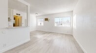 Located on Fountain Ave in the East Hollywood neighborhood of Los Angeles, this 1-bedroom, 1-bathroom unit offers a clean, modern aesthetic throughout its thoughtfully arranged single-floor layout. Light wood-style flooring runs consistently through the main living areas, complementing the crisp white walls and creating a bright, cohesive atmosphere.

The living room is the largest area of the unit, featuring multiple windows fitted with horizontal blinds that allow natural light to pour in, illuminating views of the surrounding Los Angeles streetscape, including palm trees and neighboring rooftops. A wall-mounted air conditioning unit provides climate control. The textured ceiling adds subtle architectural character throughout.

The bedroom is a well-proportioned private retreat, featuring a ceiling fan, a window with outdoor greenery views, and the same light flooring found throughout the unit. A dedicated closet provides storage, and a hallway connects the key areas of the home seamlessly.

The bathroom is finished in a clean, white tile scheme with a combined shower and soaking tub, a wall-mounted showerhead with matte black fixtures, and a vanity topped with a marble-style countertop. Wood-style flooring extends into this space as well, tying the design together.

Overall, the unit presents a refreshed, move-in-ready interior with a minimalist palette suited for comfortable urban living in central Los Angeles.