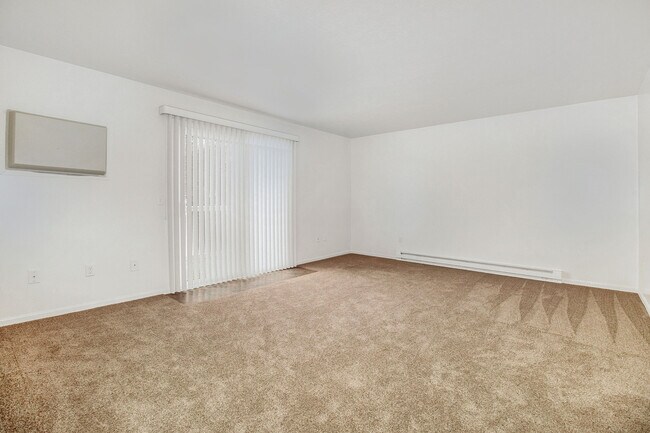 Living room with wall a/c and door to balcony - 4295 Cemetery Rd