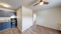 Located at 855 King Arthur Dr in Fayetteville, NC, this single-floor unit offers two bedrooms and two bathrooms in a efficiently laid-out floor plan. Wood-look laminate flooring runs throughout the home, lending a warm, cohesive aesthetic to each room.

The bedrooms are bright and functional, each featuring ceiling fans with light fixtures and windows fitted with blinds that allow natural light to filter in. The spacious primary bedroom offers two closets, providing ample storage. A wall-mounted HVAC unit ensures year-round comfort.

The kitchen is compact yet practical, outfitted with bold navy-blue cabinetry — both upper and lower — paired with dark laminate countertops, a stainless steel single-basin sink, and a black electric range with an overhead ventilation hood.

Both bathrooms are clean and straightforward in design. One features a full tub-shower combo with chrome fixtures set against crisp white surround panels, complemented by over-toilet cabinetry in white with brushed nickel hardware for convenient storage.

The textured ceilings add a subtle layer of visual detail throughout the home. The overall layout, as seen in the dollhouse view, is open and logical, making efficient use of every square foot. This unit offers a practical, move-in-ready option in Fayetteville.
