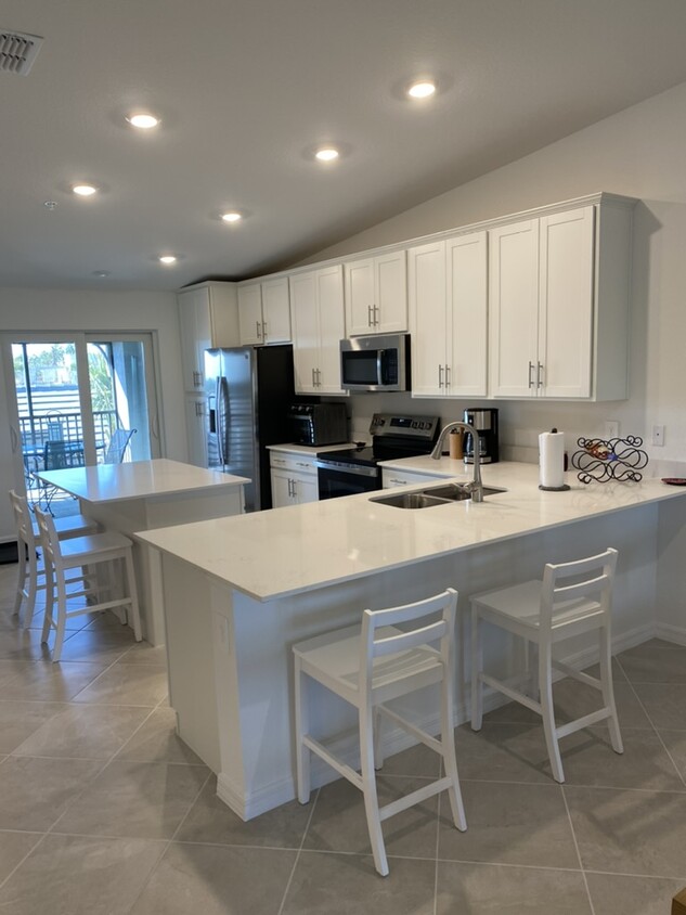 Kitchen with Sliders to Front Lanai - 17475 Opal Sand Dr