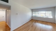 Located at 1801 Morton Ave in the vibrant Echo Park neighborhood of Los Angeles, this single-floor unit offers a clean, modern aesthetic throughout. Warm hardwood flooring flows seamlessly across the main living areas and bedrooms, lending a cohesive and inviting feel to the entire space.

The open entryway welcomes you with natural light streaming through slatted blinds and connects directly to a bright, airy living area. The updated kitchen is a standout feature, showcasing white shaker cabinetry, dark countertops, a classic white subway tile backsplash, and hexagonal floor tile. A peninsula provides additional prep and serving space, while a stainless steel sink and dishwasher add functional convenience.

The bedrooms are well-proportioned and filled with natural light from large windows that offer views of surrounding greenery. Each room is equipped with a ceiling fan for year-round comfort. Clean white walls and crisp baseboards throughout give the space a fresh, move-in-ready appearance.

The bathroom is thoughtfully designed with a backlit LED vanity mirror, dark countertop, white cabinetry, hexagonal tile flooring, and a tiled tub-shower combo with chrome fixtures, creating a sleek, contemporary feel. The overall ambiance of this unit is bright, functional, and modern — well-suited for comfortable urban living in Los Angeles.