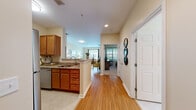 Located at 5213 Highland Glen Rd in Westwood, MA, this well-appointed one-bedroom, one-bathroom residence offers a thoughtfully designed single-floor layout that maximizes both function and comfort. The open-concept kitchen and living area serve as the heart of the home, connected by warm hardwood-style flooring that runs throughout. The kitchen features rich wood cabinetry, granite countertops, stainless steel appliances including a refrigerator, microwave, and dishwasher, and a peninsula with a built-in sink that opens toward the living space—ideal for casual dining or entertaining. The living room is bright and inviting, with neutral walls, recessed lighting, and windows that allow natural light to fill the space. The bedroom offers plush carpeting, a window with views of the surrounding greenery, and ample room for a full furniture arrangement. The bathroom is cleanly finished with a wood-vanity, white countertop, framed mirror, and a tiled shower-tub combination. Throughout the residence, the warm, neutral color palette and consistent finishes create a cohesive and comfortable ambiance, making this Westwood home a practical yet refined living space.