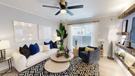 This thoughtfully designed one-bedroom, one-bathroom residence makes excellent use of its single-floor layout, delivering a cohesive and stylish living experience throughout. The living room is bright and welcoming, featuring crown molding, a ceiling fan with light fixture, and a large sliding glass door with sheer curtains that floods the space with natural light. A striking accent wall with rustic floating wood shelves and a wall-mounted TV anchors one side of the room, adding warmth and character. The kitchen is equipped with stainless steel appliances, white shaker-style cabinetry, a subway tile backsplash, and a quartz peninsula countertop with an undermount sink and matte black faucet. Open wood shelving beneath the peninsula adds a modern, functional touch, complemented by pendant lighting overhead. The bedroom comfortably accommodates a queen-sized bed, features its own ceiling fan, light wood-tone flooring, and windows that allow natural light to filter in. A dedicated closet provides ample storage. The bathroom is finished with a white vanity, a framed mirror with contemporary lighting, wood-look tile flooring, and a tiled shower-tub combination, creating a clean and polished aesthetic throughout.