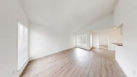 Located at 9220 Nathaniel St in Houston, TX, this single-story 2-bedroom, 1-bathroom home offers a clean, modern aesthetic throughout. The open living area is bathed in natural light from large windows fitted with classic white blinds, and features light wood-tone flooring that extends through the main living spaces. Vaulted ceilings in the entry and living room add a sense of spaciousness and airiness to the layout. The kitchen is thoughtfully designed with white shaker-style cabinetry, a subway tile backsplash, stainless steel sink, and a peninsula topped with a rich wood countertop — a functional and stylish focal point that connects the kitchen to the dining and living areas. The second bedroom benefits from vaulted ceilings and abundant natural light from dual windows. The primary bedroom features soft carpeting, a ceiling fan, and access to the full bathroom, which includes a vanity with white cabinetry, hardwood-style flooring, and a full soaking tub with a built-in surround. Two closets provide practical storage throughout the home. The consistent white walls, warm flooring tones, and natural light create a cohesive and welcoming atmosphere throughout this well-appointed Houston residence.