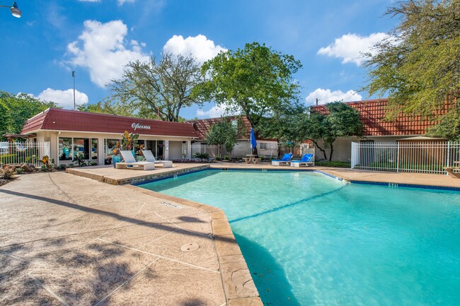 A resort-style swimming pool with ample deck space for lounging and socializing. - Tucasa Townhomes