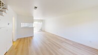 Located in Thousand Oaks, CA, this two-story, 2-bedroom, 2-bathroom home is spread across two thoughtfully laid-out floors. The main level features a bright, open-plan living and dining area with light wood flooring throughout, large windows dressed with vertical blinds, and a sliding glass door that fills the space with natural light and offers views of the surrounding greenery. The galley-style kitchen is outfitted with white cabinetry, a coil electric range, a dishwasher, and a single-basin sink — all finished in a clean, all-white palette. Upstairs, both bedrooms are well-proportioned, each featuring light wood floors, large windows with outdoor views, and built-in sliding door closets that maximize storage efficiency. The primary bedroom is generously sized with ample natural light. The two bathrooms are clean and functional; one features a grey vanity with gold hardware, a large mirror, a tub-shower combo, and a high window for natural light, while the other includes a white vanity with a wall-mounted mirror and towel bar. Three closets throughout the home provide additional storage. The bright, neutral palette and consistent light wood flooring create a cohesive, airy ambiance throughout the entire space.