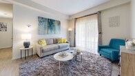 This single-floor residence at 200 Blakeslee in Bristol, Connecticut, offers a thoughtfully designed layout that balances comfort and functionality throughout. The living room serves as a welcoming centerpiece, featuring large sliding glass doors dressed with sheer curtains that flood the space with natural light and provide access to the outdoors. Light-toned walls and hard-surface flooring extend into the entry and kitchen area, where an open-concept design connects a peninsula breakfast bar to a well-equipped kitchen outfitted with rich wood cabinetry and white appliances. The primary bedroom is generously proportioned, featuring plush wall-to-wall carpeting, a large window for ample natural light, and direct access to both a private en-suite bathroom and a dedicated closet with storage. A second bedroom mirrors the comfortable aesthetic with carpet flooring, a bright window, a closet, and a cozy, versatile layout suitable for a variety of uses. The full bathroom features a wide vanity with solid countertops, a large mirror, and tile flooring. Throughout the residence, neutral tones, consistent finishes, and an abundance of natural light create a clean, inviting atmosphere that is both practical and comfortable.