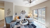 This single-floor residence offers a thoughtfully designed layout that balances comfort and modern style. The open-concept living area is bright and welcoming, featuring neutral walls, ceiling fan, and a sliding glass door that leads to a private patio, allowing natural light to flow freely throughout the space. The kitchen is well-equipped with dark wood cabinetry, granite-style countertops, white appliances including a dishwasher, range, and refrigerator, as well as wood-look flooring and a window that brings in additional natural light.

The unit includes two carpeted bedrooms, each fitted with ceiling fans. The primary bedroom offers generous space, large windows with sheer curtains, and access to a closet. The second bedroom features its own walk-in closet, providing ample storage. Both rooms maintain a calm, neutral palette with warm tones.

The bathroom continues the consistent design language of the home, showcasing dark cabinetry with granite countertops, wood-look flooring, a tub-shower combination, and a window for natural ventilation. Throughout the residence, the cohesive use of neutral tones, modern fixtures, and quality finishes creates a clean, contemporary ambiance that is both functional and inviting.