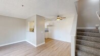 This two-story residence at 8888 Citrus Ave in Fontana, California offers 2 bedrooms and 3 bathrooms thoughtfully distributed across two floors. The main level hosts the living room, kitchen, and a hallway, while the upper floor accommodates the bedrooms and additional bathrooms.

The kitchen is well-appointed with white shaker cabinetry, granite-style countertops, a tile backsplash, stainless steel appliances including a range and dishwasher, and light hardwood-style flooring. The living room features the same light flooring and opens directly to a private outdoor patio through a sliding glass door, allowing for natural light and easy indoor-outdoor flow.

Both bedrooms are carpeted and feature neutral toned walls and textured ceilings. The primary bedroom offers a comfortable footprint with a sliding-door closet and direct access to its own bathroom. The second bedroom also benefits from a window with outdoor views, bringing in natural light. The bathrooms are clean and functional, featuring granite-topped vanities with white cabinetry, hardwood-style flooring, and a full tub and shower combination in at least one. A dedicated half-bath provides added convenience. The overall design is clean, neutral, and move-in ready.