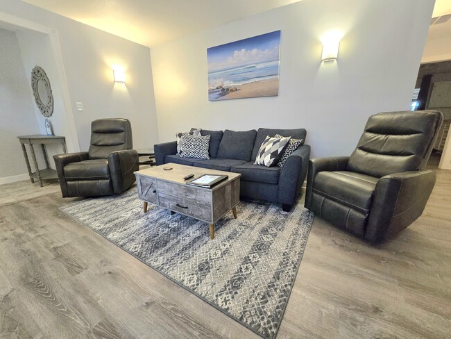 The coffee table has a lift-up top. The sofa contains a queen sofa bed. - 206 Cordoba St